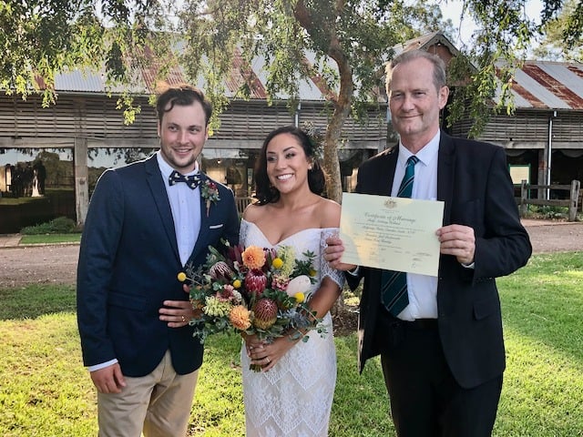 Bride and groom with celebrant holding the signed marriage certificate at Elizabeth Farm, Rosehill, NSW