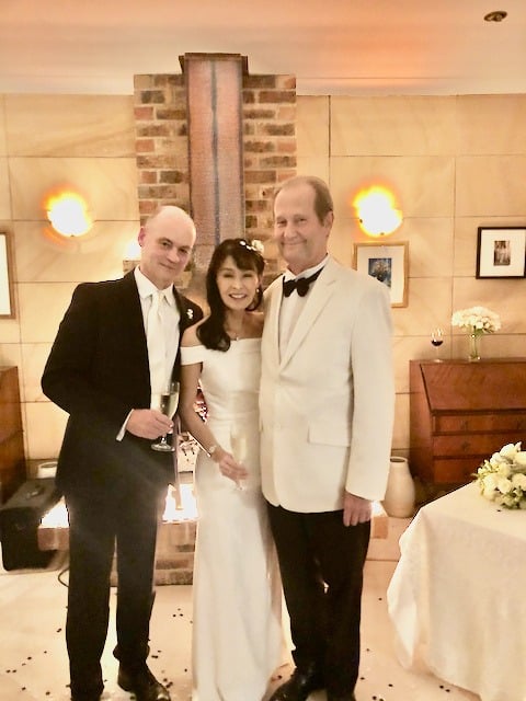 Bride in her wedding gown posing with two men in suits at the reception at Roseville NSW