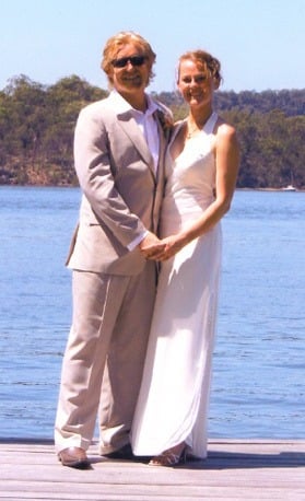 Couple holding hands and smiling on a waterfront jetty at Bar Point NSW